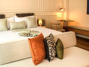a bedroom with a large bed with pillows on it at Oliver Mexico City in Mexico City +99 photos