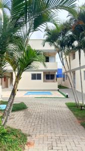 a building with palm trees in front of it at Miau de Pipa in Pipa