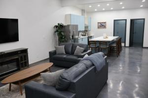 a living room with a couch and a table at Glacier Luxury Retreat Montana Sky Apartment 2 in Hungry Horse