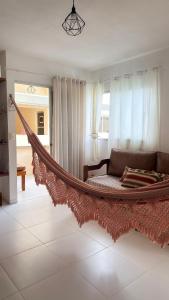 a hammock in the middle of a living room at Miau de Pipa in Pipa +39 photos