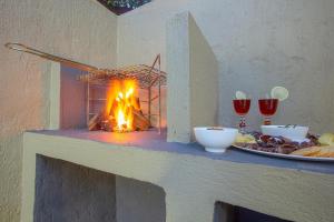 a fire on a counter with a plate of food at Baobab at 36 Rissik in Komatipoort