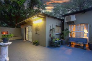 a house with a patio with potted plants at Baobab at 36 Rissik in Komatipoort