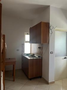 a kitchen with a sink and a counter top at Infinity room in Velipojë