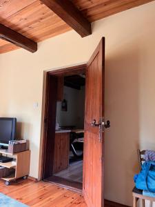 an open wooden door in a room with a desk at Pokój i Spokój in Szarki