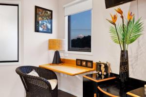a living room with a desk and a window at Headlands Hotel in Opunake +16 photos