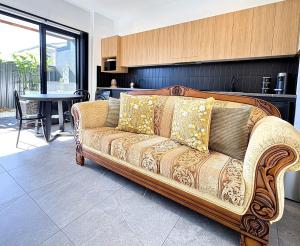 a couch in a living room with a table at Korora's Haven Coffs Harbour in Kororo Basin