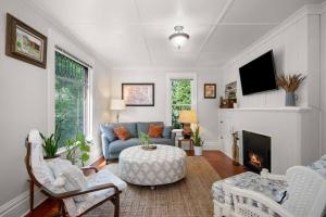 a living room with a couch and a fireplace at Chic Vintage Vibes Stylish Stay Near It All in Spokane