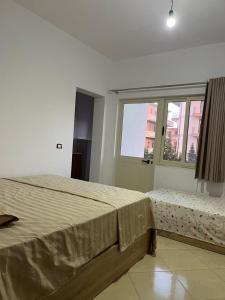 a bedroom with a large bed and a window at Infinity room in Velipojë