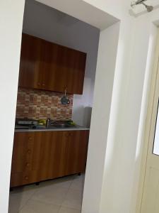 a kitchen with a sink and a counter top at Infinity room in Velipojë