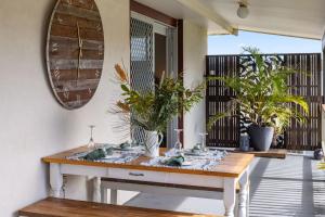 a dining room with a table and potted plants at Ocean Vibes in Scotts Head