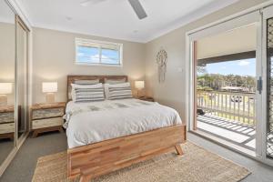 a bedroom with a bed and a balcony at Ocean Vibes in Scotts Head