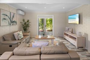 a living room with a couch and a table at Ocean Vibes in Scotts Head