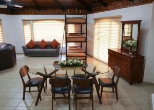 a living room with a glass table and chairs at Campestre La Fuente in Monterrey