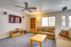 a living room with a couch and a ceiling fan at Easy AFB Commute! Clearfield Unit w/ Private Patio in Clearfield