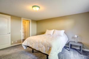 a bedroom with a bed and a table with a lamp at Easy AFB Commute! Clearfield Unit w/ Private Patio in Clearfield