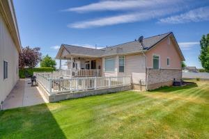 a house with a large deck on a yard at Easy AFB Commute! Clearfield Unit w/ Private Patio in Clearfield