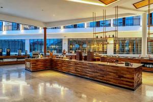 a large lobby with a bar in a building at NDC Resort & Spa in Manado