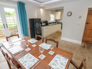 a kitchen with a table with wine glasses on it at White Lea in Richmond
