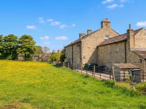 an old brick building in a field of grass at White Lea in Richmond