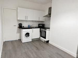 a kitchen with a washing machine and a washer at Private Flat Near City Centre in Peterborough