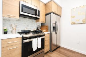 a kitchen with a black stove and a microwave at Splendid Executive Suites in Long Beach