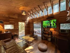 a living room with a couch and a tv at NAT PARK Isumi RV in Iwada
