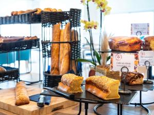 a display of different types of bread and pastries at ibis Styles Biarritz Plage in Biarritz