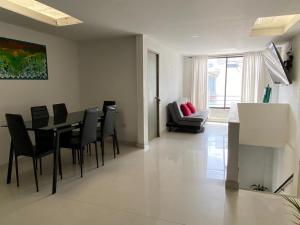 a dining room and living room with a table and chairs at Tunja Magic Habitación in Tunja