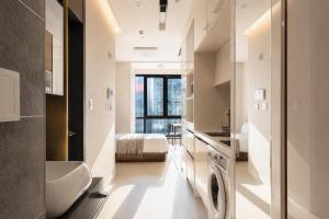 a bathroom with a sink and a washing machine in a room at Urbanstay Seomyeon in Busan