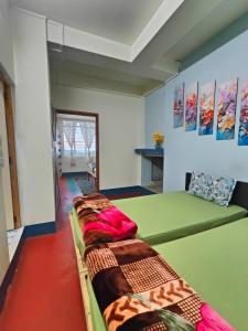 a room with several beds in a room at Pine Forest Home stay with City View in Shillong