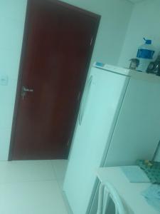 a door in a room with a bed and a mirror at Guimarães in Viçosa
