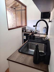 a small kitchen with a sink and a sink at KANTIQ House in Cusco +52 photos