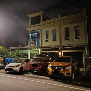 three cars parked in front of a house at Topville Homestay in Kangar