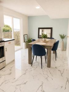 a kitchen and dining room with a table and chairs at Lagoon Views Near Bird Sanctuary in Victoria +37 photos