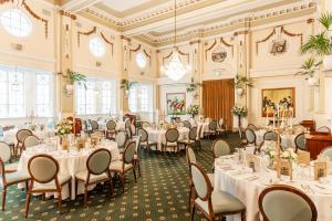 a banquet hall with tables and chairs in a room at Castlereagh Boutique Hotel, an Ascend Collection Hotel in Sydney