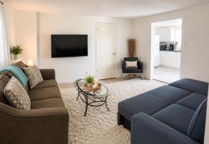 a living room with a couch and a tv at Lagoon Views Near Bird Sanctuary in Victoria