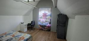 a room with a bedroom with a bed and a desk at Belle chambre 2 in Seraing