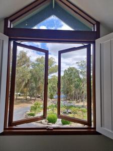 a window with a view of a park at Girraween Country Inn in Ballandean