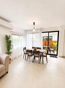 a dining room with a table and chairs at Modern Villa 2 BR Near Airport, Beaches, Dining in Punta Cana