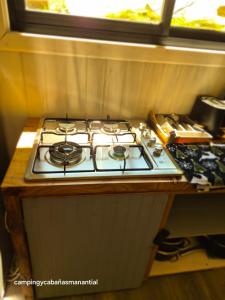 a stove top oven sitting on top of a counter at cabañasmanantialpanguipulli in Panguipulli