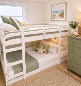 a white bunk bed with a bench in a room at Mermaid Manor in Brighton Beach +2 photos