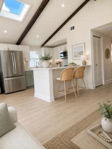 a kitchen with a refrigerator and a table and chairs at Mermaid Manor in Brighton Beach