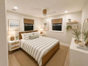 a bedroom with a bed and a desk and two windows at Mermaid Manor in Brighton Beach