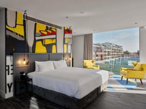 a hotel room with a bed and a balcony at Hotel Woolstore 1888, Sydney - Handwritten Collection in Sydney +71 photos