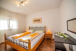 Posteľ alebo postele v izbe v ubytovaní Apartments Kati
