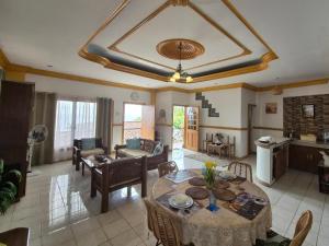a living room with a table and a couch at Danao RM House in Idanao