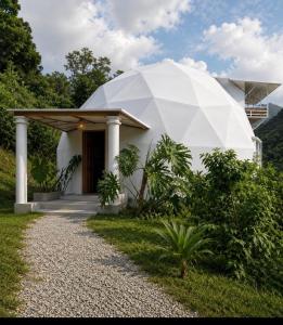 a house with a large white dome on top of it at Kayala Domes - Unique Luxury Domes in the Mountains - 4x4 recommended in La Ese