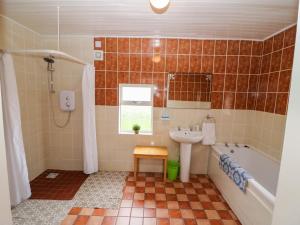 a bathroom with a sink and a tub and a toilet at Forest View in Teeranearagh +45 photos