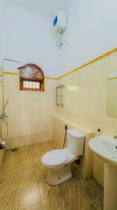 a bathroom with a toilet and a sink at Senu Bungalow in Ragama +13 photos