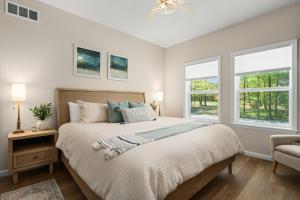 a bedroom with a large bed and two windows at The Four Seasons Escape in Pocono Lake +119 photos
